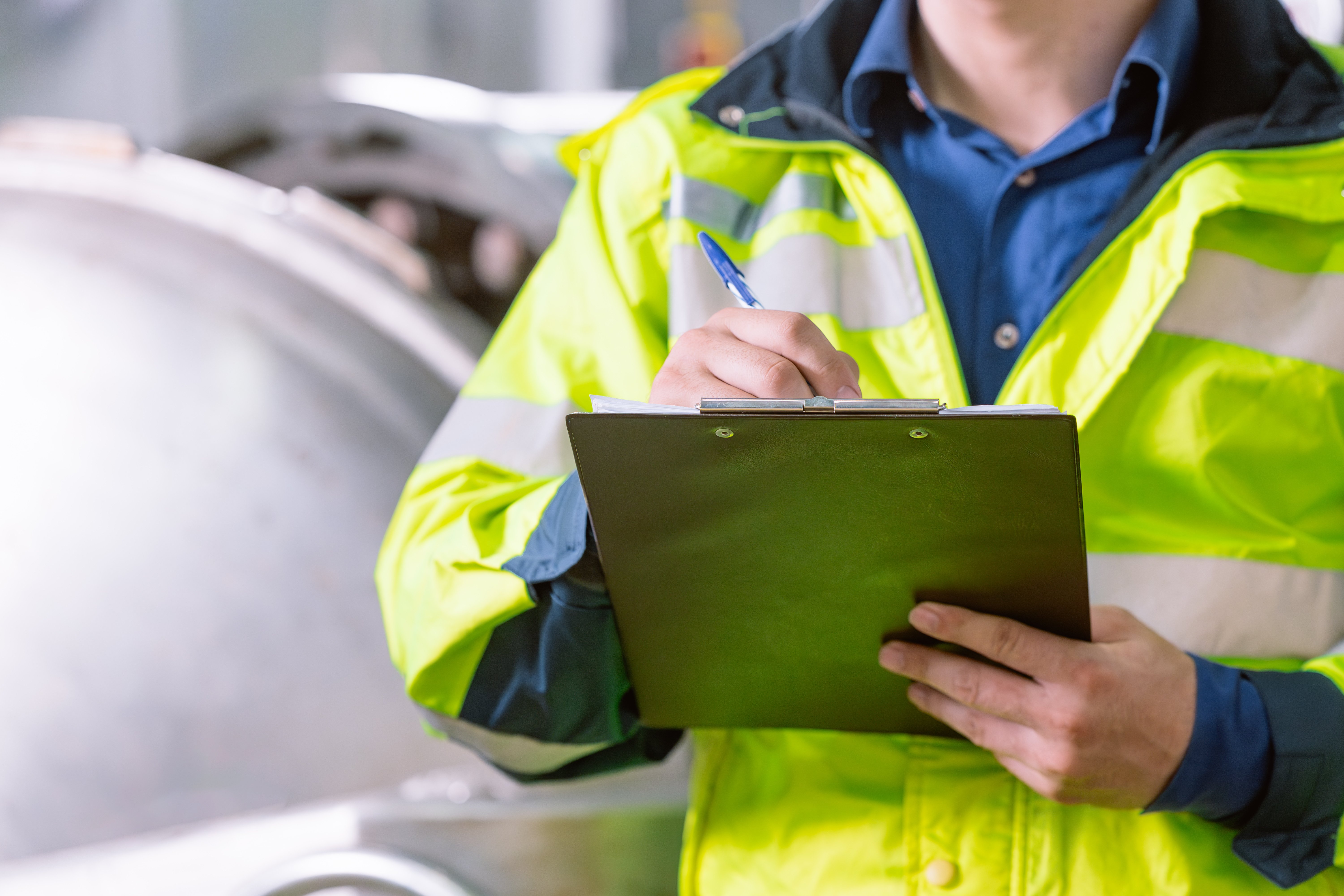 inspector-writes-on-clipboard-in-industrial-settin-2026-03-19-23-11-08-utc
