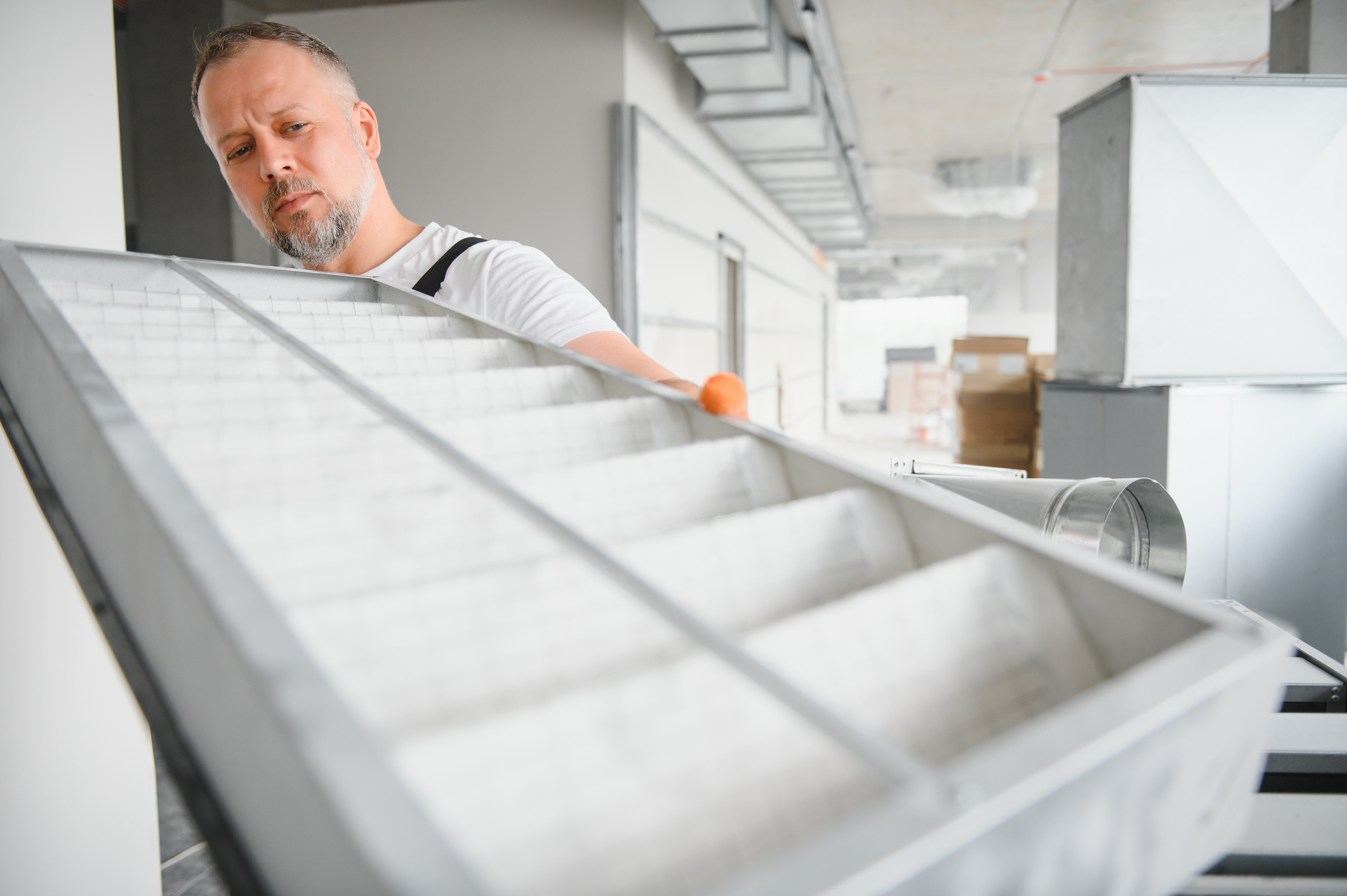 man-inspecting-air-filter-in-commercial-environmen-2026-01-08-23-01-07-utc